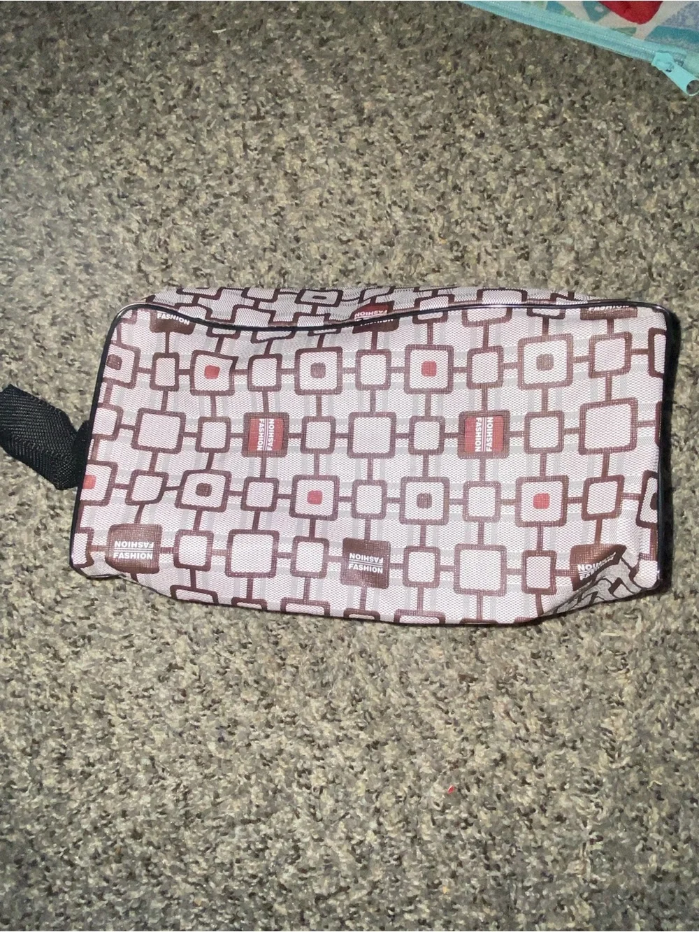 Brown and white geometric patterned travel toiletry bag